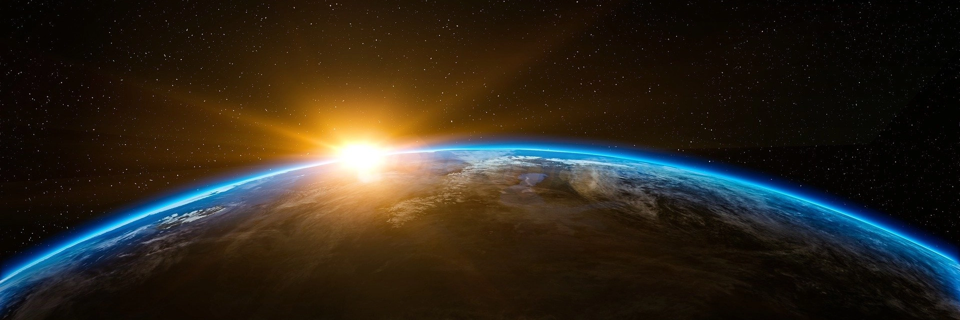 Viaggi spirituali: immagine del pianeta terra col sole che sorge
